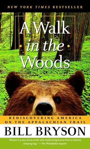 Cover of 'A Walk in the Woods' by Bill Bryson featuring a forest scene with a bear's face in the foreground.