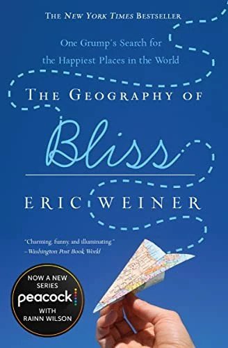 Book cover of The Geography of Bliss by Eric Weiner featuring a hand holding a folded map paper airplane against a blue background.